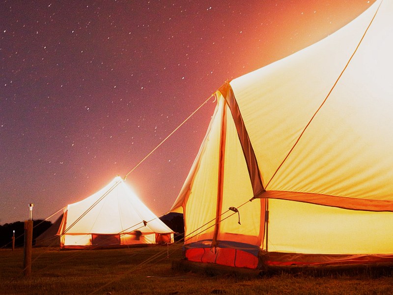 Glamping bell tent lit up from outside